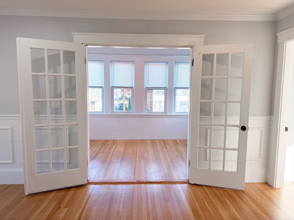 39 Pond Street, Unit 2 Framingham, MA 01702 - Photo 5 of 18 an empty room with wooden floor and windows