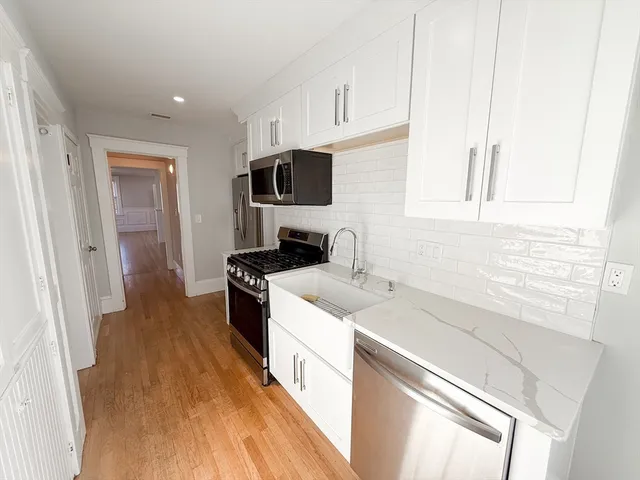 a kitchen with a sink stove and refrigerator