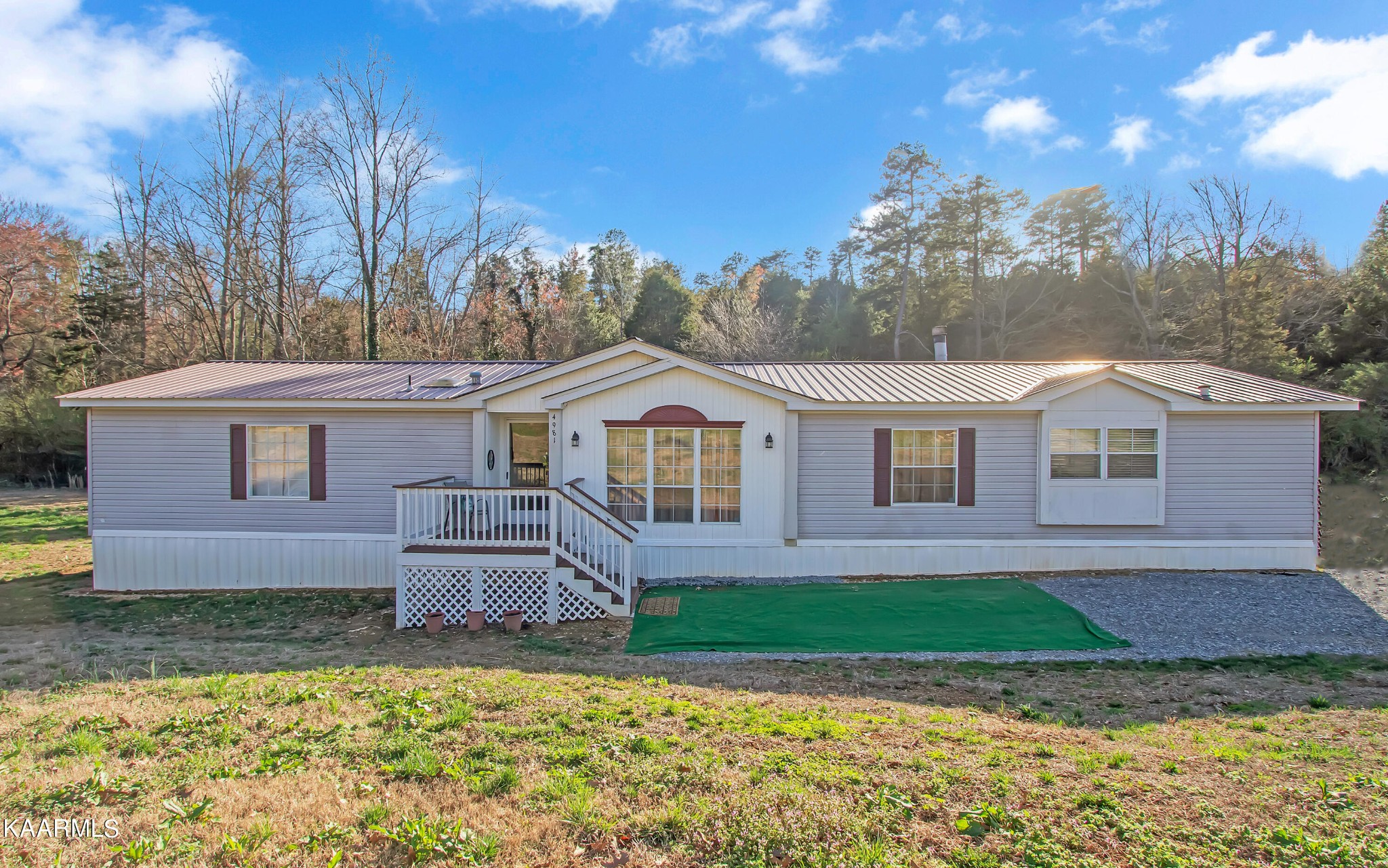 4981 Malone Road Loudon, TN 37774 - Photo 1 of 35 a front view of a house with a yard and garage