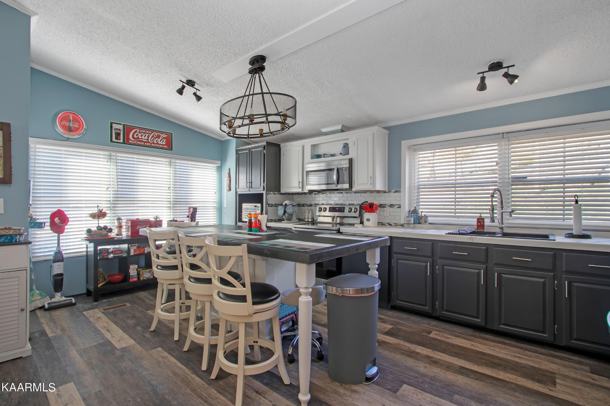 4981 Malone Road Loudon, TN 37774 - Photo 22 of 35 a kitchen with stainless steel appliances granite countertop a sink dishwasher a dining table and chairs with wooden floor