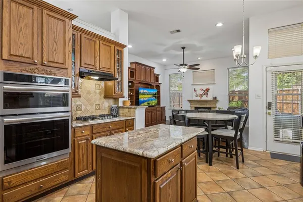 a kitchen with a stove cabinets and counter space