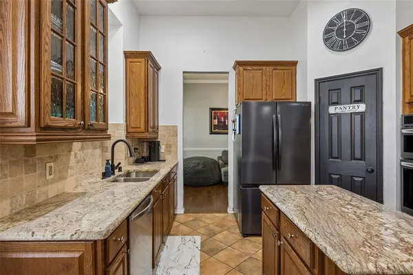 a kitchen with a refrigerator and a sink