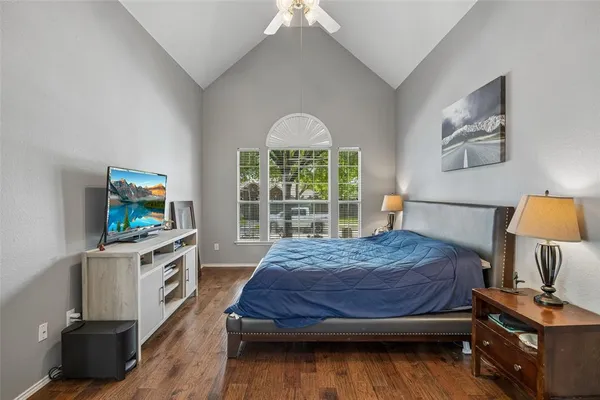 a spacious bedroom with a bed and a window