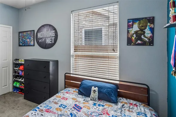 a front view of a bedroom with baby crib and hanging chair