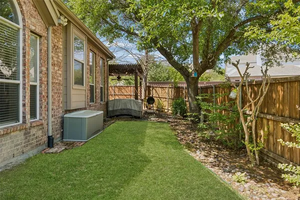 a view of house with backyard