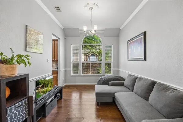 a living room with furniture a window and a chandelier