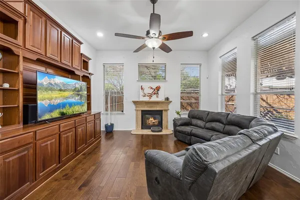 a living room with furniture a fireplace and a flat screen tv