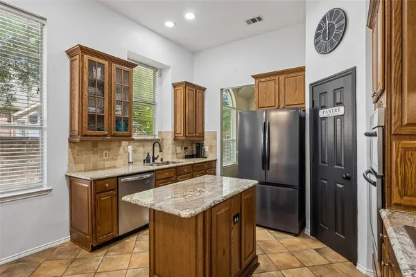 a kitchen with a refrigerator and a sink