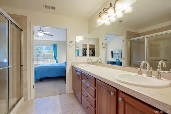 a spacious bathroom with a double vanity sink a mirror and a bathtub