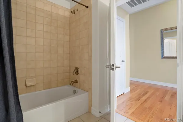 a bathroom with a tub shower and vanity