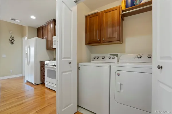 a view of washer and dryer with wooden floor