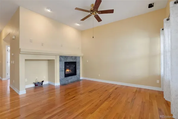 wooden floor in an empty room with a fireplace