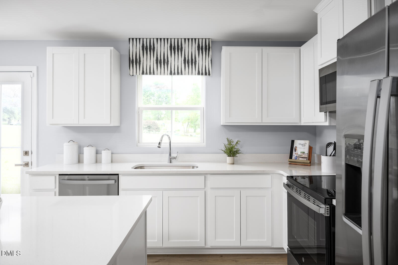 199 Brook Bawn Road Wendell, NC 27591 - Photo 2 of 25 a kitchen with stainless steel appliances granite countertop a sink a stove a refrigerator and cabinets