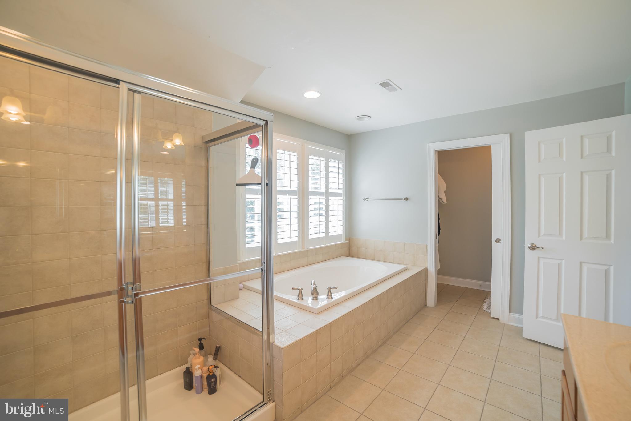 3746 Spring Meadow Drive Ellicott City, MD 21042 - Photo 15 of 40 a bathroom with a tub and a shower