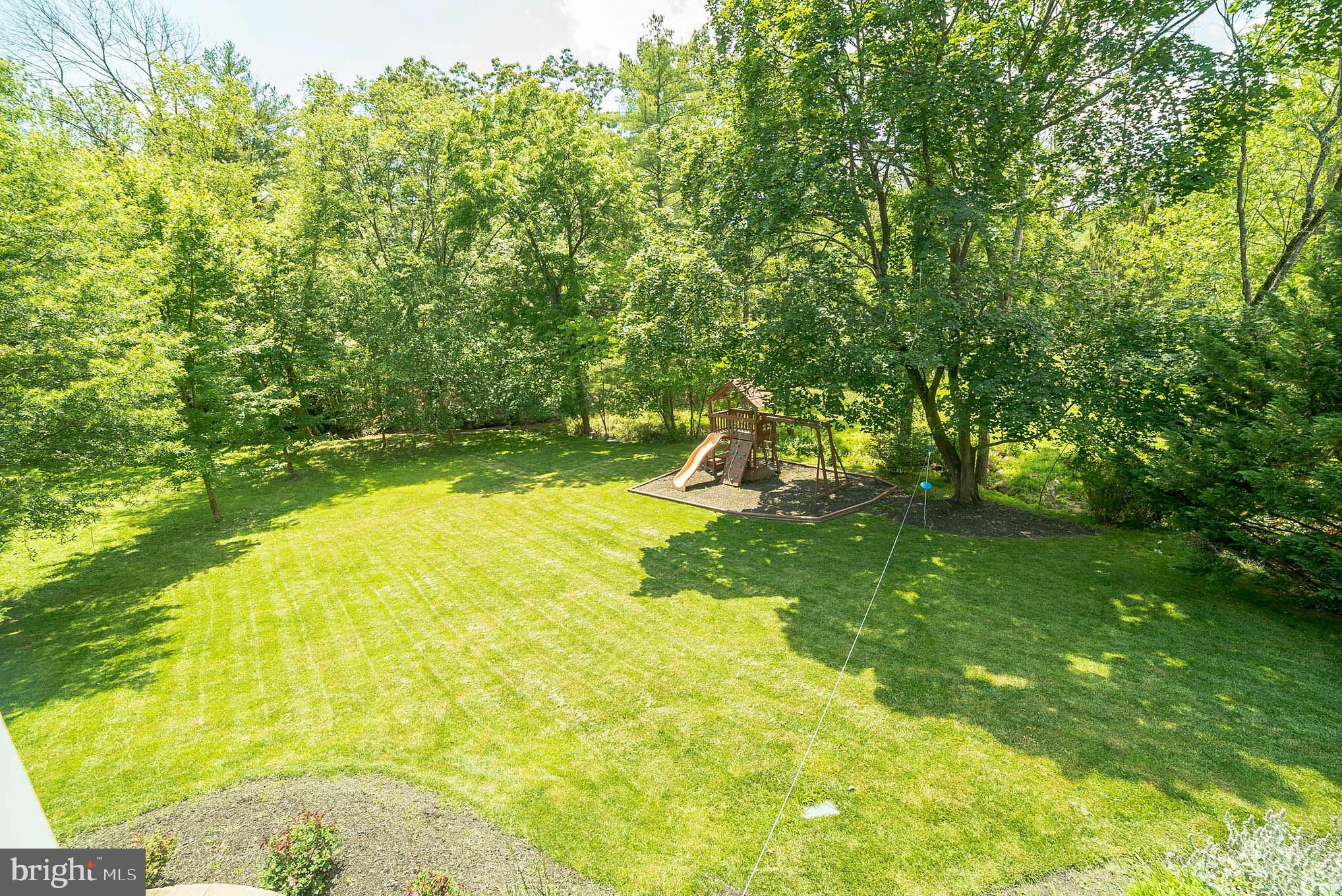 3746 Spring Meadow Drive Ellicott City, MD 21042 - Photo 18 of 40 a view of a swimming pool with a garden and trees
