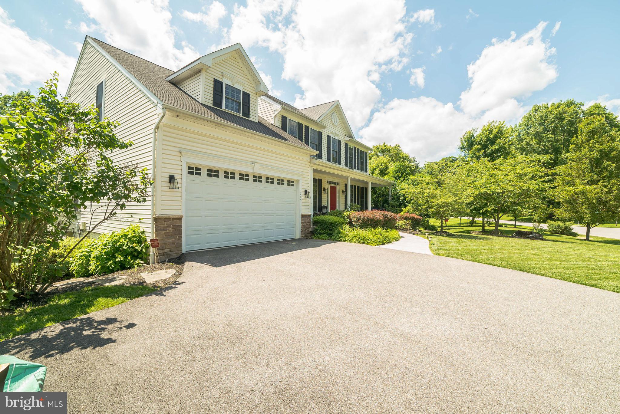 3746 Spring Meadow Drive Ellicott City, MD 21042 - Photo 19 of 40 a front view of a house with a yard and garage
