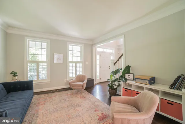 a bedroom with furniture and a large window