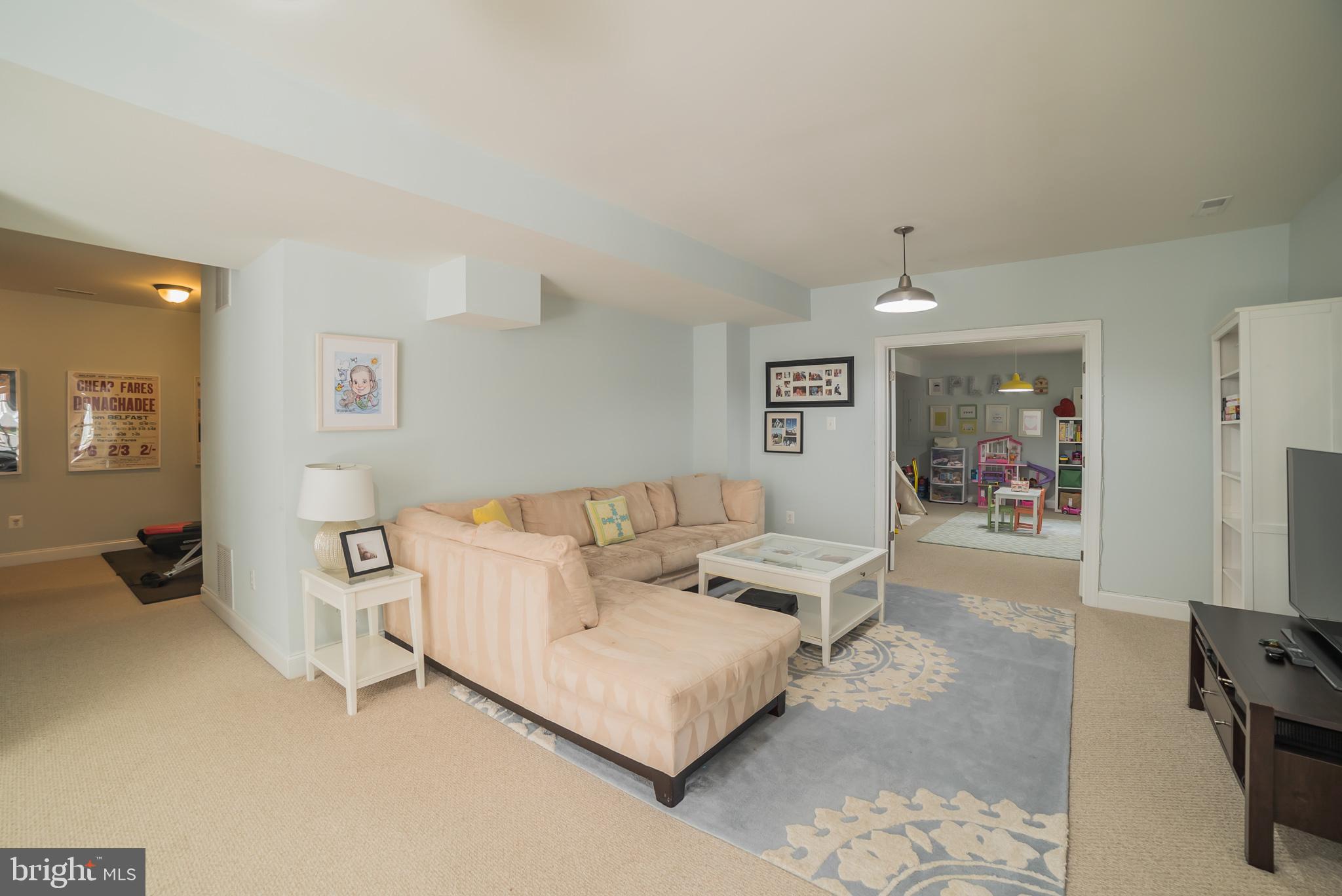 3746 Spring Meadow Drive Ellicott City, MD 21042 - Photo 25 of 40 a living room with furniture and a flat screen tv