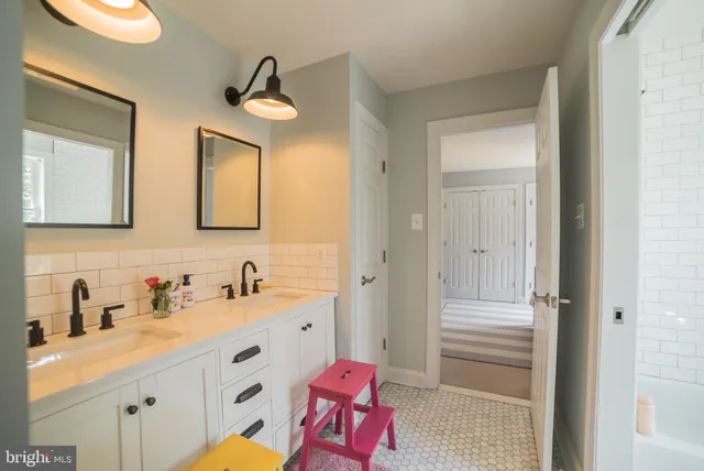 a bathroom with 2 sink and a mirror