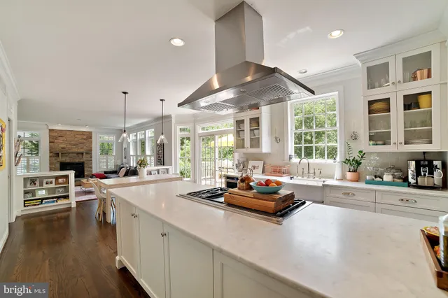 a kitchen with sink stove and cabinets
