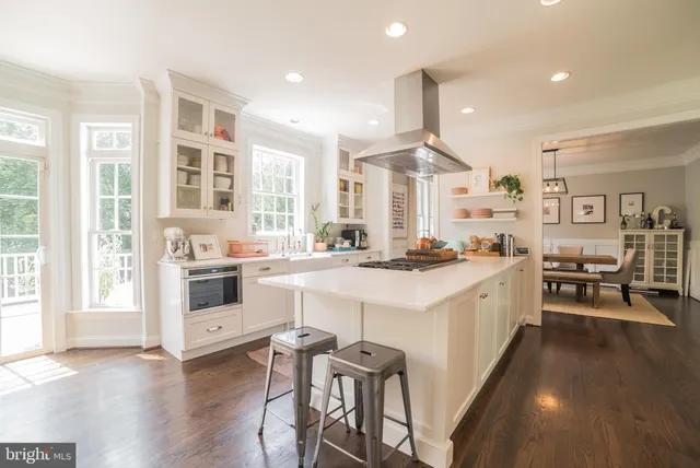 a kitchen with white cabinets and white appliances