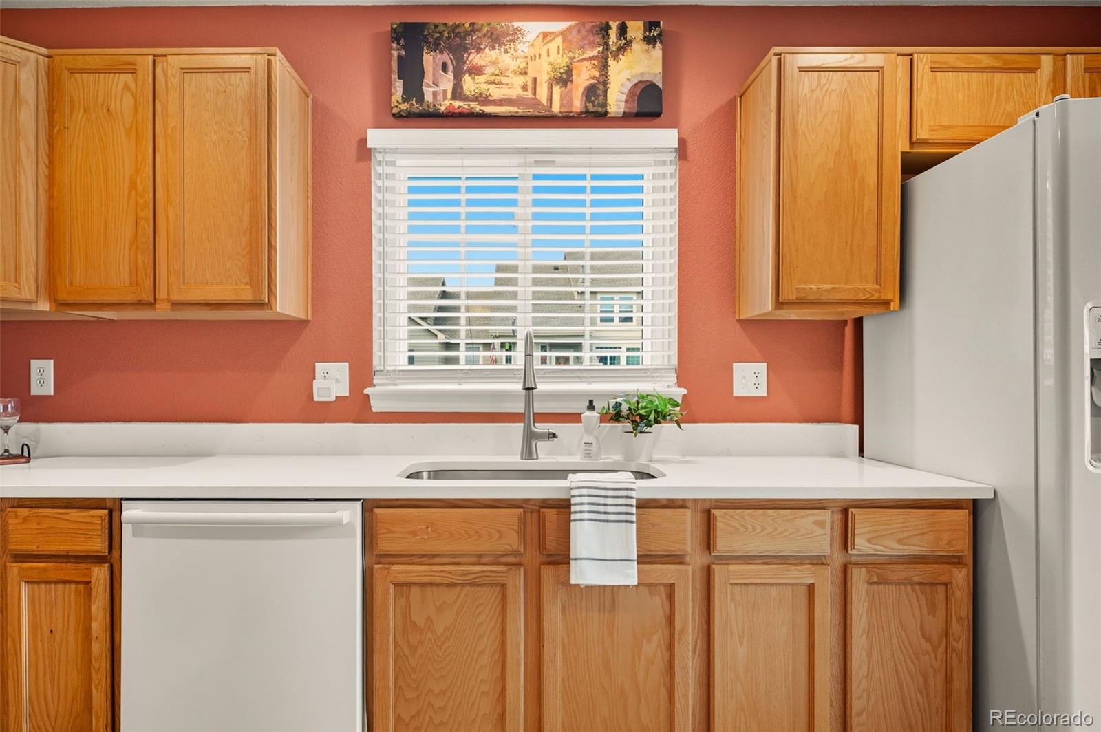 10058 Grove Court, Unit E Westminster, CO 80031 - Photo 12 of 48 a kitchen with granite countertop cabinets and window