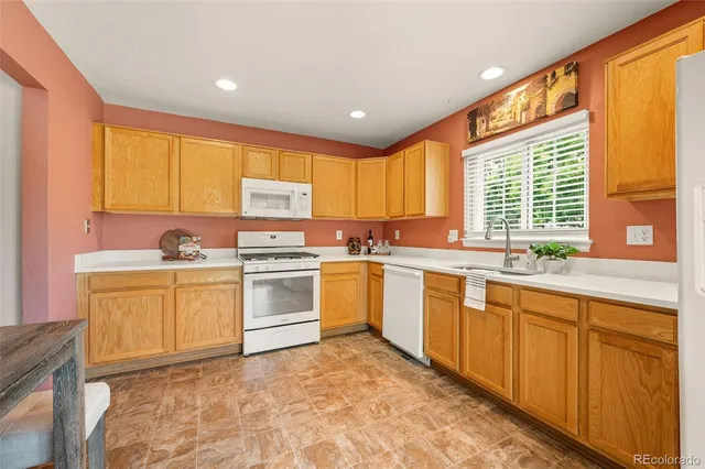 a kitchen with granite countertop a stove sink and cabinets