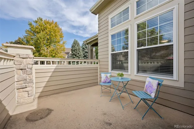 a building outdoor space with patio furniture and potted plants