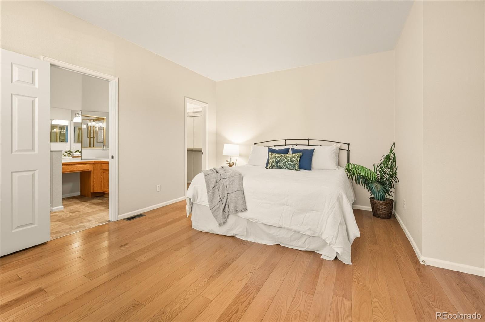 10058 Grove Court, Unit E Westminster, CO 80031 - Photo 17 of 48 a bedroom with a bed and wooden floor