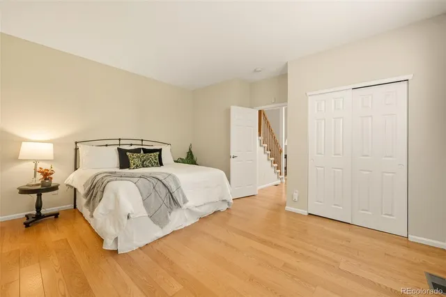 a bedroom with a bed and wooden floor