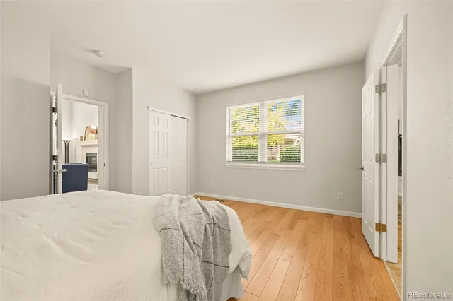 a bed sitting in a spacious bedroom next to a window