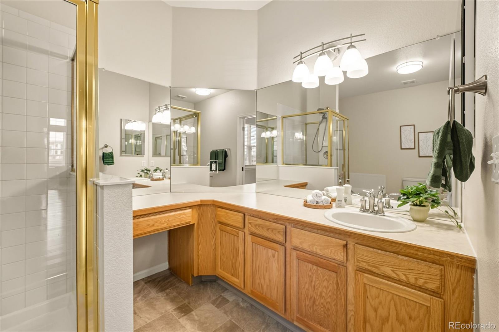 10058 Grove Court, Unit E Westminster, CO 80031 - Photo 21 of 48 a spacious bathroom with a sink double vanity and a mirror