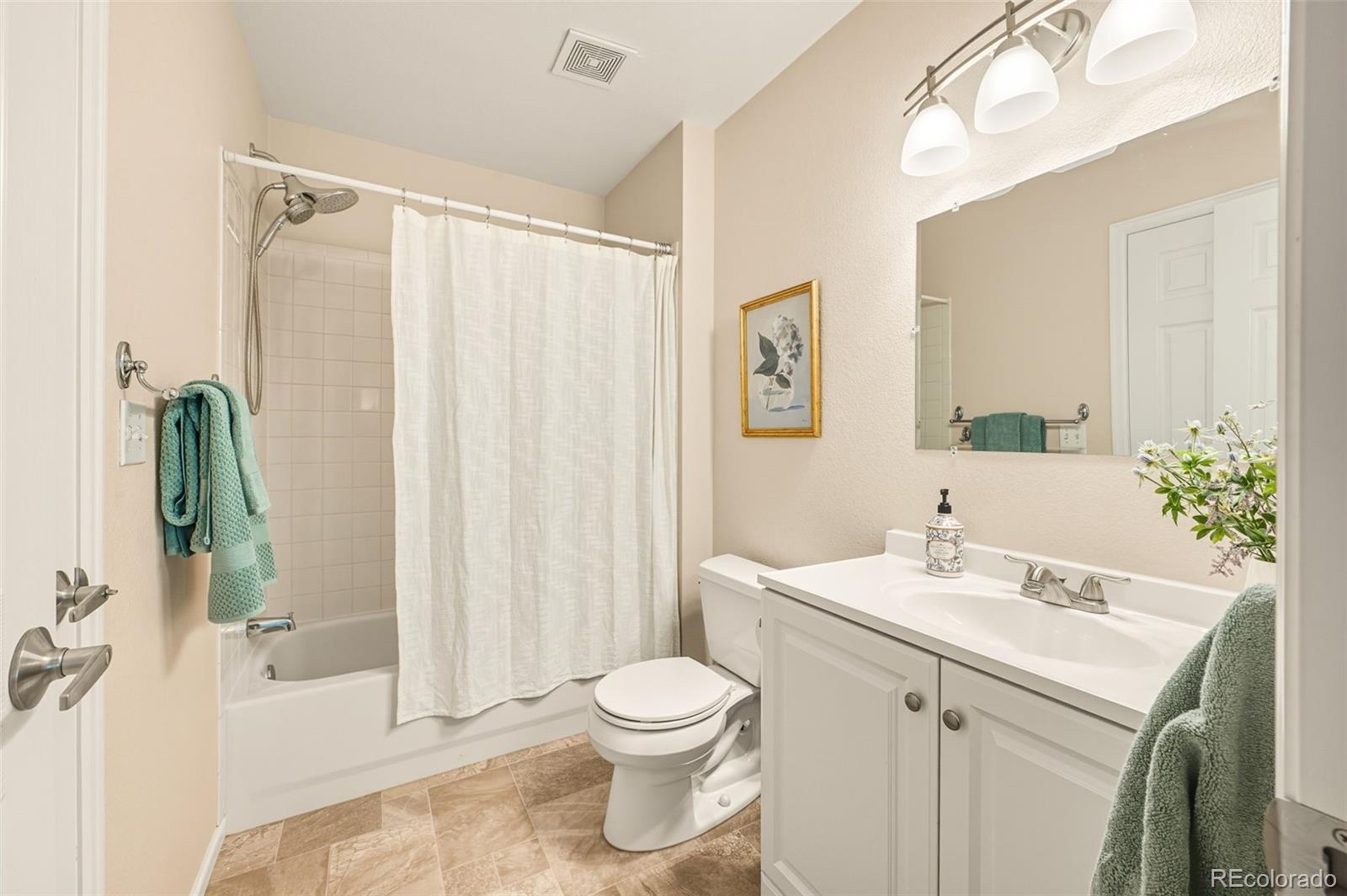 10058 Grove Court, Unit E Westminster, CO 80031 - Photo 25 of 48 a bathroom with a sink a toilet and shower