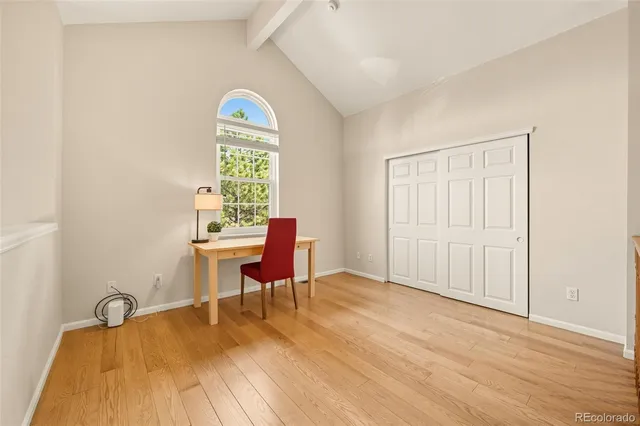 a view of a workspace with wooden floor