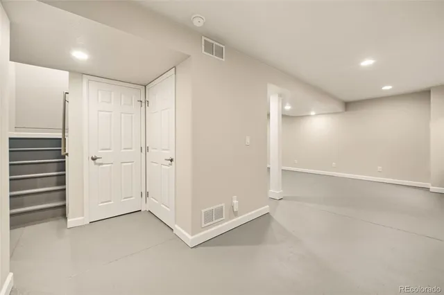 an empty room with a empty space and windows