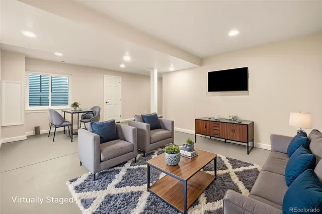 an empty room with windows and fireplace