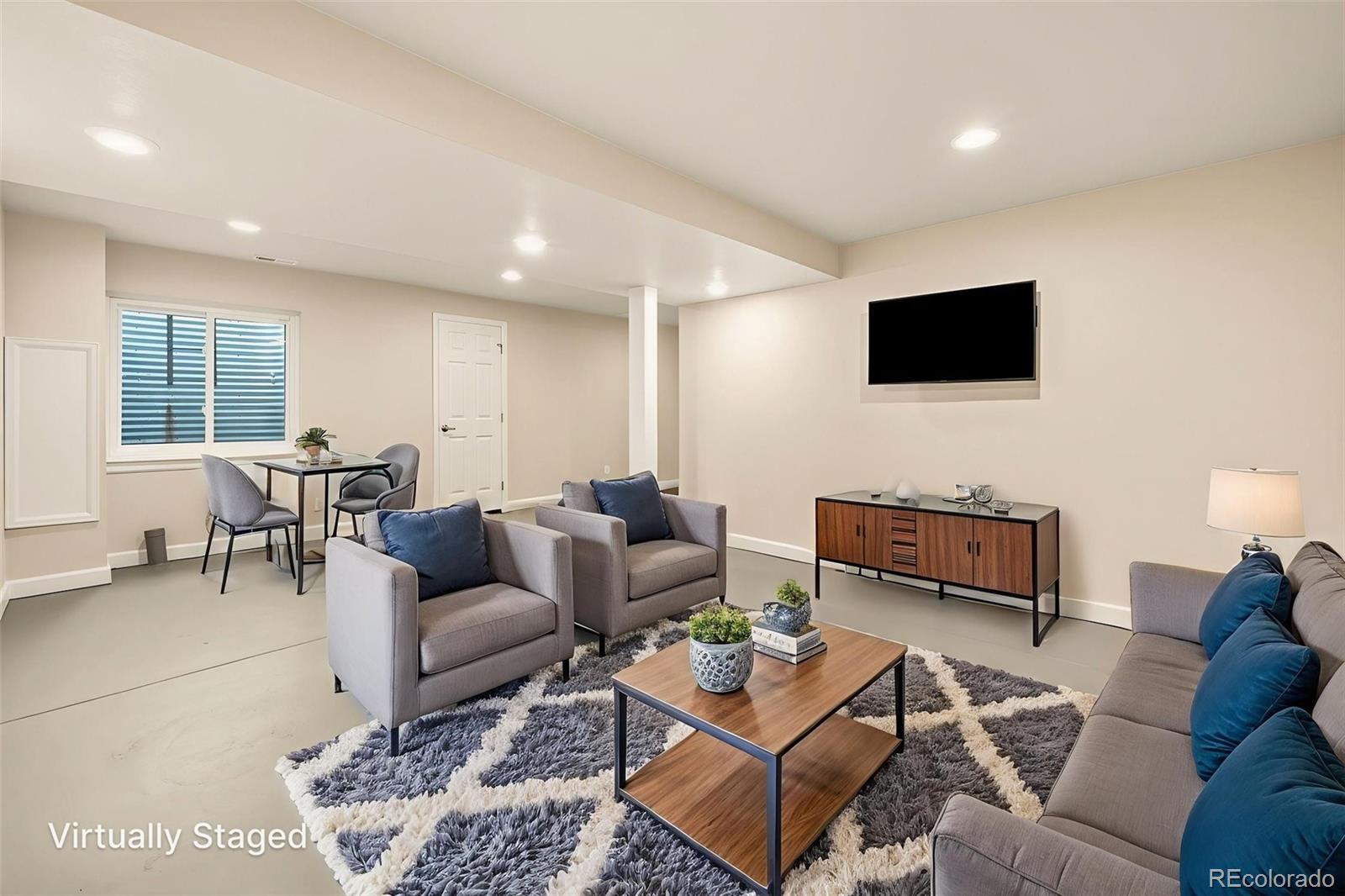10058 Grove Court, Unit E Westminster, CO 80031 - Photo 35 of 48 a living room with furniture and a flat screen tv