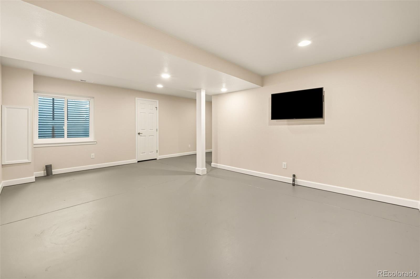 10058 Grove Court, Unit E Westminster, CO 80031 - Photo 36 of 48 an empty room with windows and fireplace