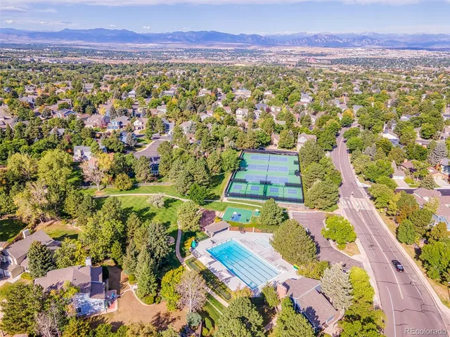 an aerial view of residential houses with outdoor space and swimming pool