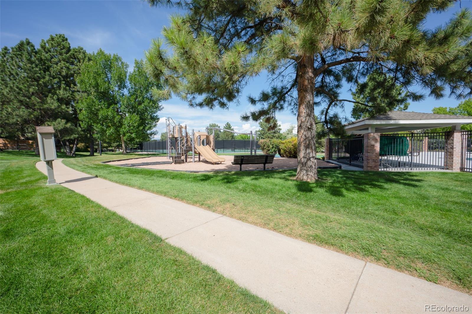 10058 Grove Court, Unit E Westminster, CO 80031 - Photo 45 of 48 a view of a house with a yard porch and sitting area