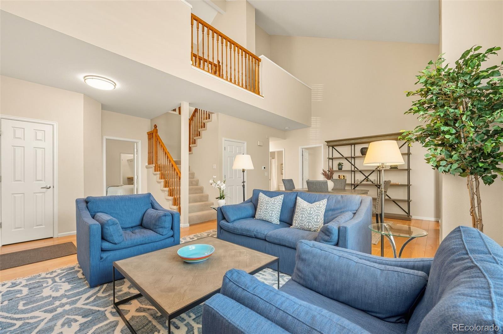 10058 Grove Court, Unit E Westminster, CO 80031 - Photo 5 of 48 a living room with furniture and a potted plant
