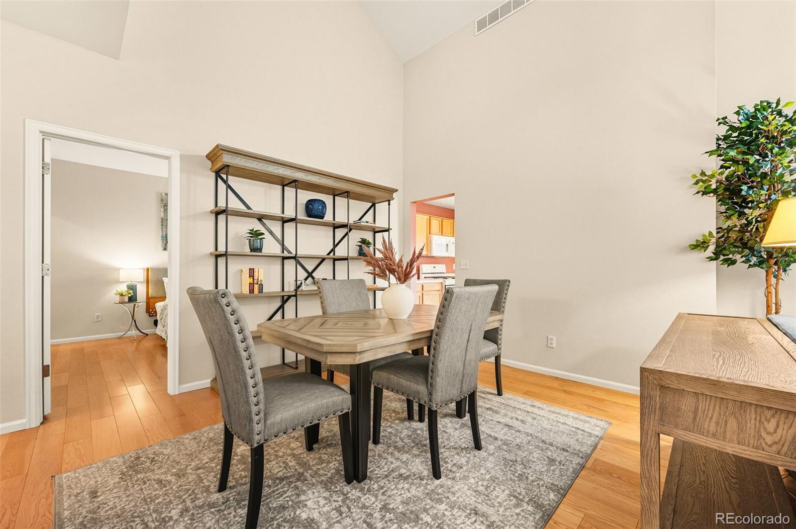 10058 Grove Court, Unit E Westminster, CO 80031 - Photo 9 of 48 a view of a dining room with furniture and wooden floor