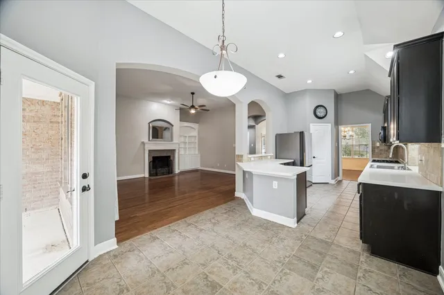 a large kitchen with a sink and a stove top oven