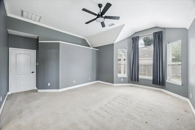a view of a livingroom with a ceiling fan and window