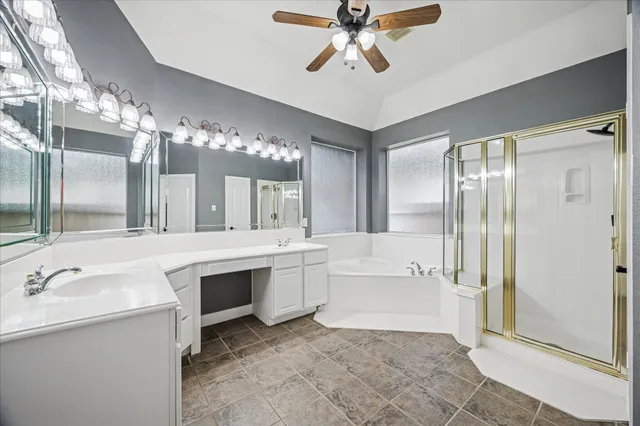 a spacious bathroom with a sink a large mirror and a bathtub