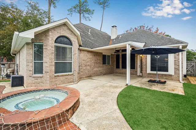 a view of a house with backyard and sitting area
