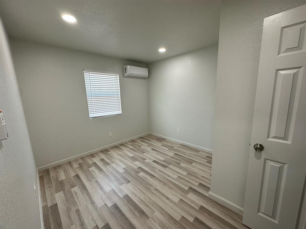 229 Pvt Road, Unit 200 Alvord, TX 76225 - Photo 12 of 25 a view of empty room with wooden floor and fan