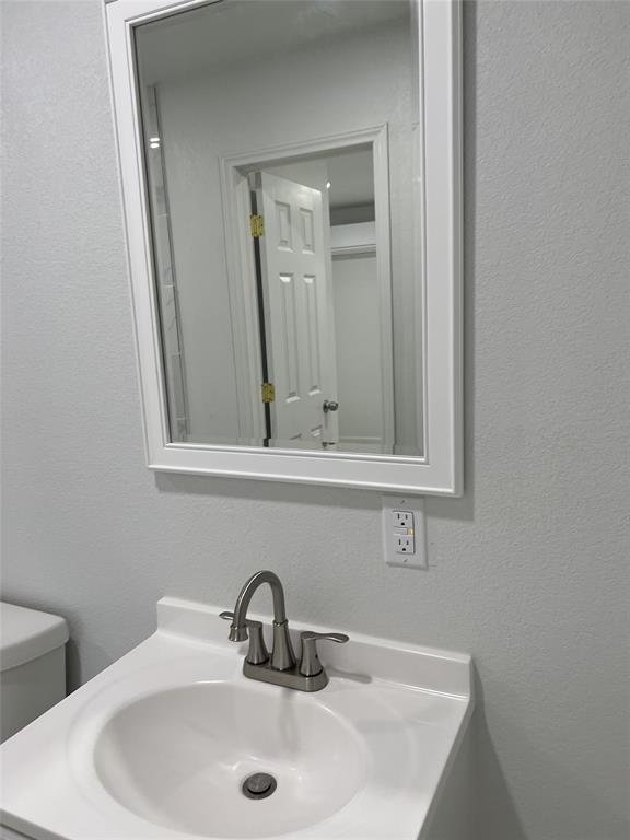 229 Pvt Road, Unit 200 Alvord, TX 76225 - Photo 7 of 25 a bathroom with a sink and a mirror