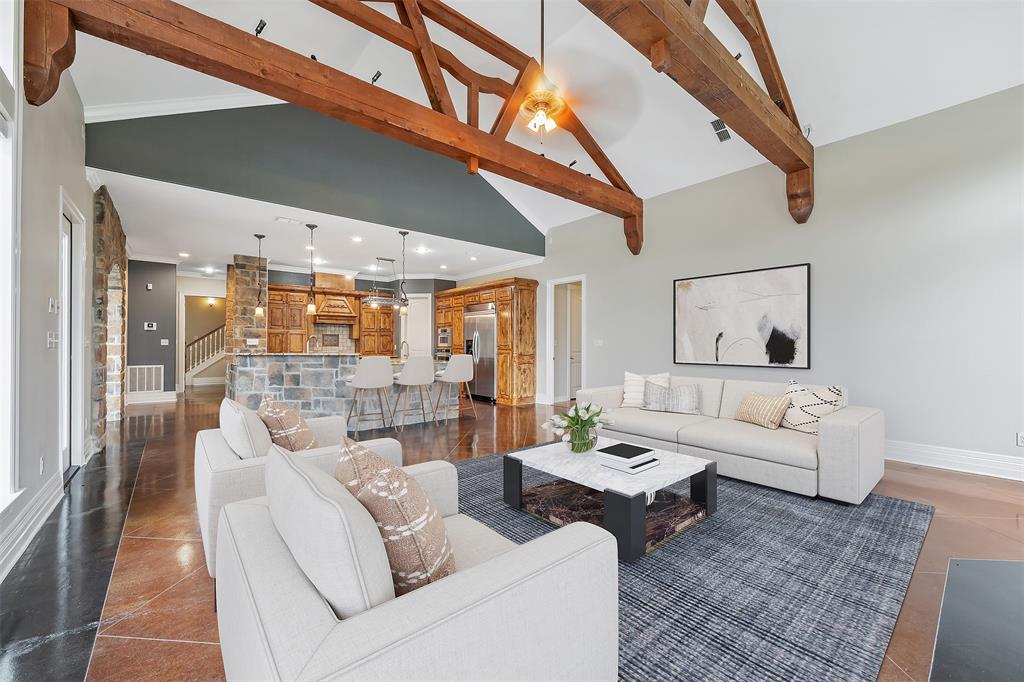 20389 County Road 178 Flint, TX 75762 - Photo 11 of 40 Vaulted ceiling with exposed wood beams, stone accent walls, and an open-concept layout