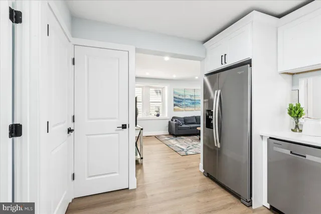 a kitchen with a refrigerator and a sink